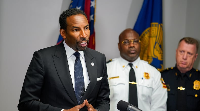 The owner of Manuel’s Tavern said the midtown Atlanta bar was vandalized early Wednesday ahead of a speech that Mayor Andre Dickens (left) delivered to Democratic supporters. (Ben Hendren for the Atlanta Journal-Constitution)