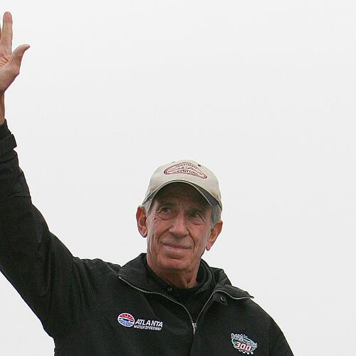 FILE - NASCAR legend Ned Jarrett waves to the fans as he is introduced before the start of the NASCAR BUSCH Nicorette 300 at Atlanta Motor Speedway in Hampton, Ga., March 18, 2006. (AP Photo/John Amis, File)