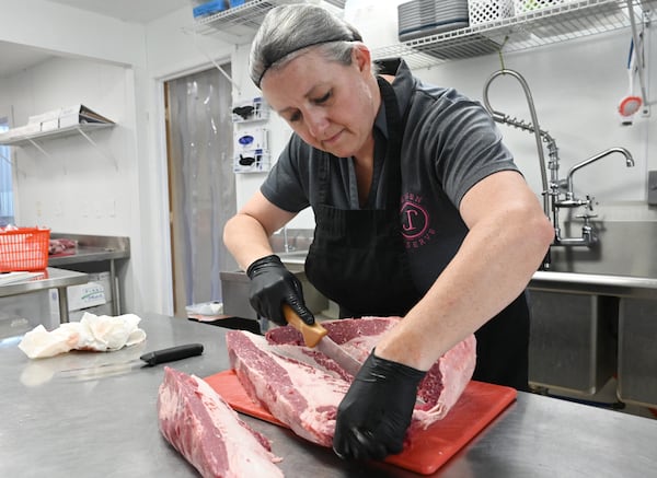 Laura Jensen helped to bring the Meishan pig breed back from extinction in the U.S. and runs an organization that focuses on breeding and studying them. In addition to raising the pigs, Jensen runs a butcher shop on the property that employs only women butchers. (Hyosub Shin/AJC)