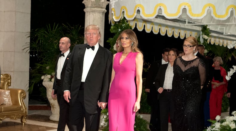 President Donald Trump and Melania Trump arrive at the Diamond Centennial Red Cross Ball at Mar-a-Lago Club Saturday.