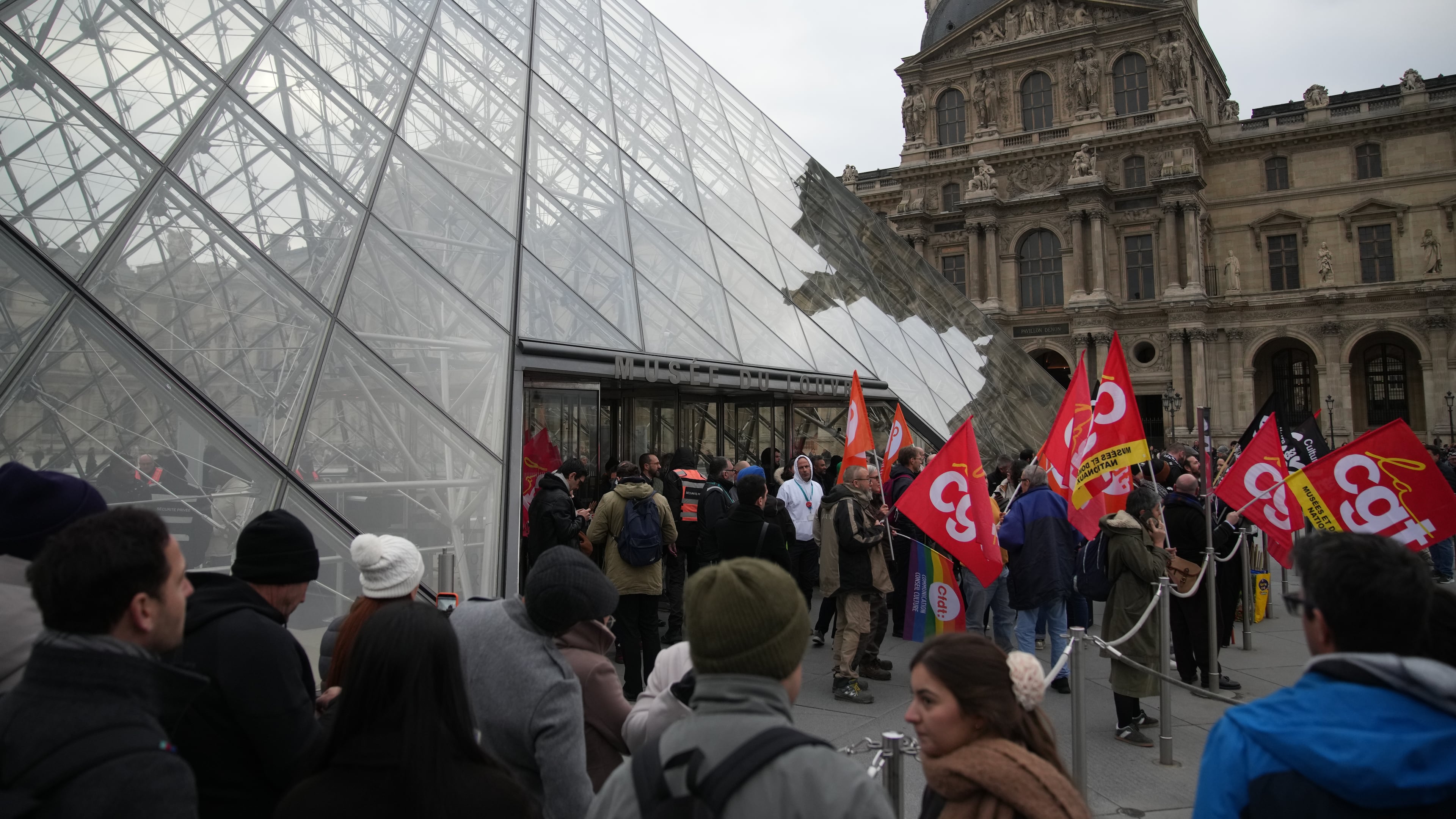 Unionists demonstrate at the entrance of the Louvre museum after employees have voted to extend a strike that has disrupted operations at the world's most visited museum, Wednesday, Dec. 17, 2025 in Paris. (AP Photo/Christophe Ena)
