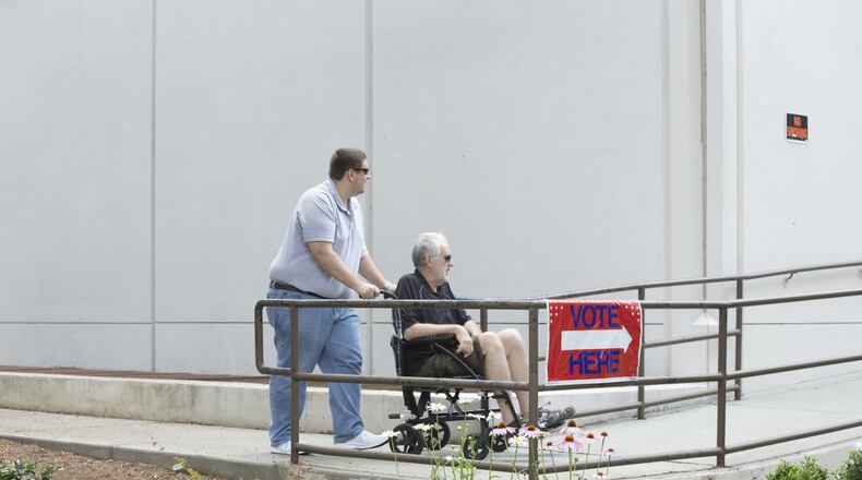 Early voters make their way Saturday into a Fulton County polling location ahead of the June 20 runoff between Republican Karen Handel and Democrat Jon Ossoff. CHAD RHYM/AJC