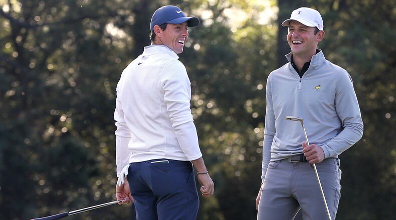 One day he's fighting fires, another Matt Parziale, right, is laughing it up with Rory McIlroy during a Masters practice round. (Curtis Compton/ccompton@ajc.com)