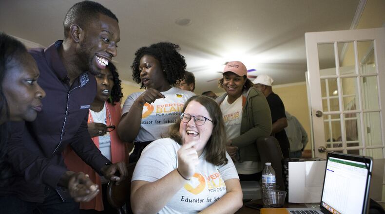 Everton “EJ” Blair, Jr. (left), candidate for Gwinnett County Board of Education District 4, celebrates with his campaign manager, Chelsea Kearns, as they look at voting results in his favor from precincts in the Shiloh district, during an election night watch party at his home in Snellville on Tuesday, Nov. 6, 2018. (Casey Sykes for The Atlanta Journal-Constitution)