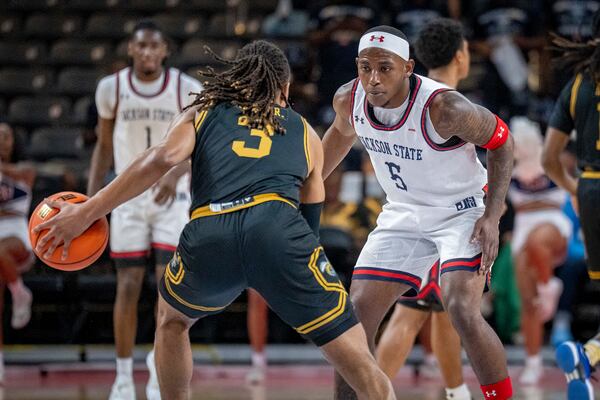 Jackson State guard Keiveon Hunt (5) defends against Alabama State guard CJ Hines (3) during the first half of an NCAA basketball game in the championship of the Southwest Athletic Conference Championship tournament Saturday, March 15, 2025, in College Park, Ga. (AP Photo/Erik Rank)