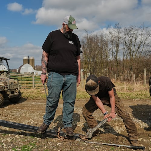 Blake Greier, 13, works to repair a hitch as his father, Wayne, left, helps Tuesday, March 10, 2026, in Canfield, Ohio. (AP Photo/Joshua A. Bickel)