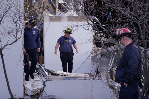 Brownsburg irefighters survey storm damage to a warehouse in Brownsburg, Ind., Thursday, April 3, 2025. (AP Photo/Michael Conroy)
