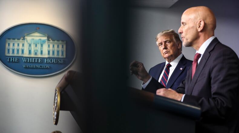 President Donald Trump watches Stephen Hahn, Food and Drugs commissioner, during a news conference announcing an emergency use authorization of a plasma treatment for COVID-19, at the White House in Washington, Aug. 23, 2020. Emergency-use authorizations, a formerly obscure corner of regulatory law, have become a centerpiece of the government’s response to the coronavirus pandemic. (Oliver Contreras/The New York Times)