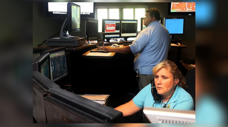 Communications Officers Chad Jenkins and Michelle Schneider handle calls in the Roswell Police 911 Center in 2010.