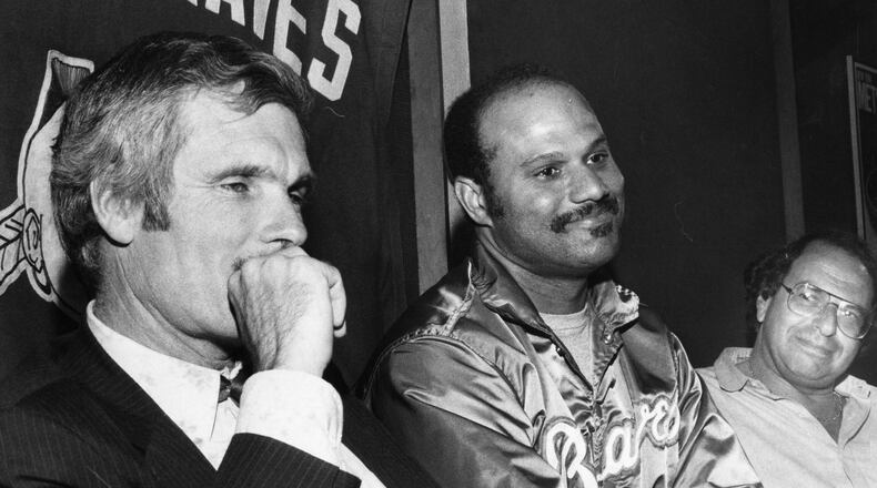 Braves first baseman Chris Chambliss (middle) sits next to team owner Ted Turner (left) at a press conference. AJC file photo