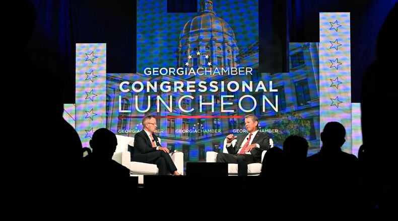 Gov. Brian Kemp (right) speaks during the Georgia Chamber of Commerce’s annual congressional luncheon in Athens on Wednesday. (Hyosub Shin/AJC)