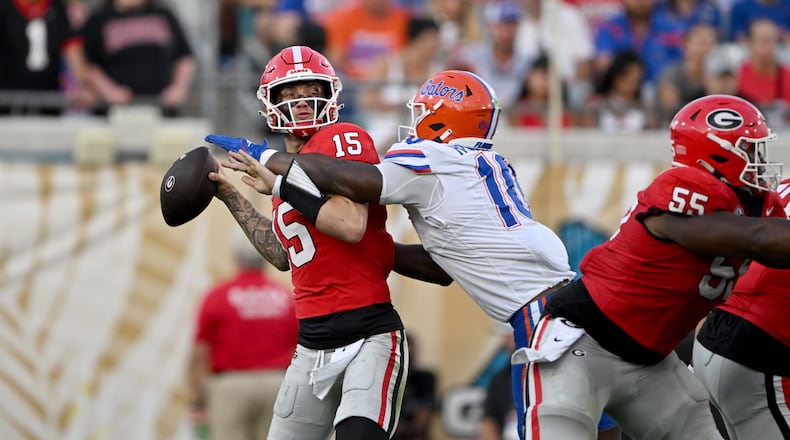 Georgia quarterback Carson Beck (15) is sacked by Florida linebacker Grayson Howard (10) during the second half in the NCAA football game at EverBank Stadium, Saturday, November 2, 2024, in Jacksonville, Fla. Georgia won 34-20 over Florida. (Hyosub Shin / AJC)