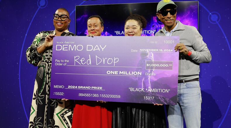 The founders of RedDrop receiving the $1 million grand prize at the 2024 Black Ambition Demo Day.
From left to right: Felecia Hatcher, CEO of Black Ambition; Monica Williams and Dana Roberts, founders of RedDrop; and Pharrell Williams, founder of Black Ambition.
CREDIT: Jason Mendez, Getty Images/Black Ambition