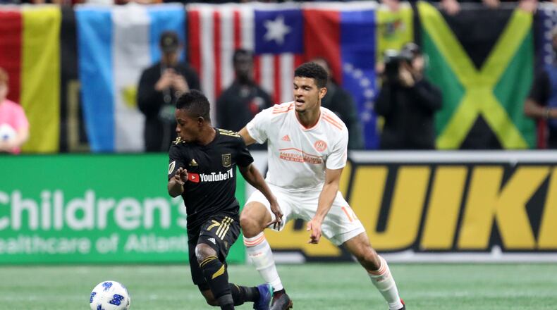 April 7, 2018. Atlanta United defender Miles Robison battles a ball in the mid field against Los Angeles FC #7 Latif Blessing during the first half.