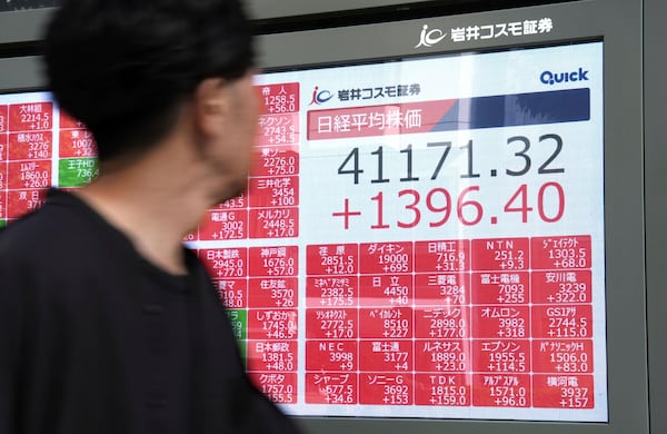 A person looks at an electronic stock board showing Japan's Nikkei index at a securities firm Wednesday, July 23, 2025, in Tokyo. (Kyodo News via AP)