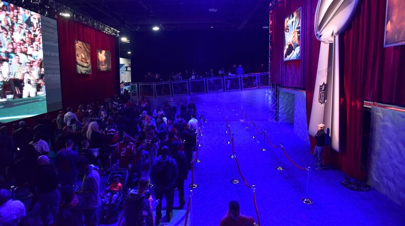 Visitors line up to take their photograph with the Vince Lombardi Trophy during Super Bowl Experience inside Georgia World Congress Center on Wednesday, January 30, 2019. (HYOSUB SHIN / HSHIN@AJC.COM)