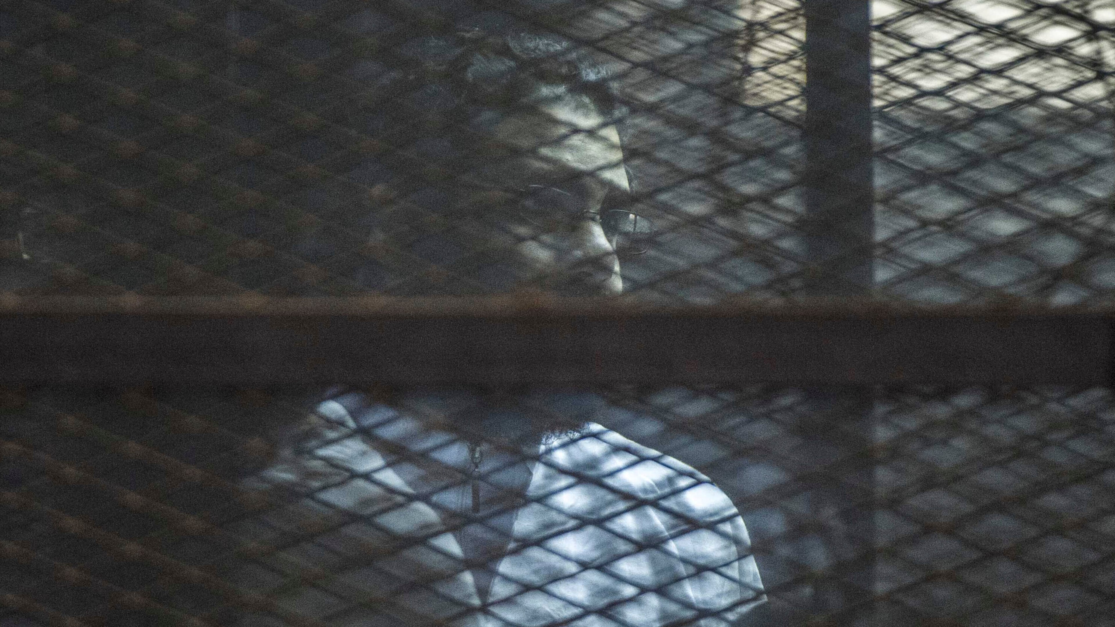Prominent Egyptian activist Alaa Abd el-Fattah stands in a cage during a verdict hearing for 21 people over an unauthorized street protest in 2013, in a courtroom in Cairo, Egypt, on Feb. 23, 2015. (AP Photo)