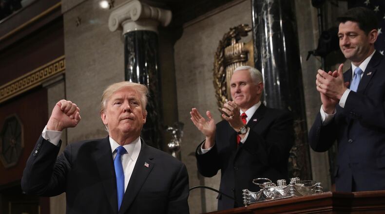 President Donald Trump gestures as he finishes his first State of the Union address in the House chamber of the U.S. Capitol to a joint session of Congress Tuesday, Jan. 30, 2018 in Washington, as Vice President Mike Pence and House Speaker Paul Ryan applaud. (Win McNamee/Pool via AP)