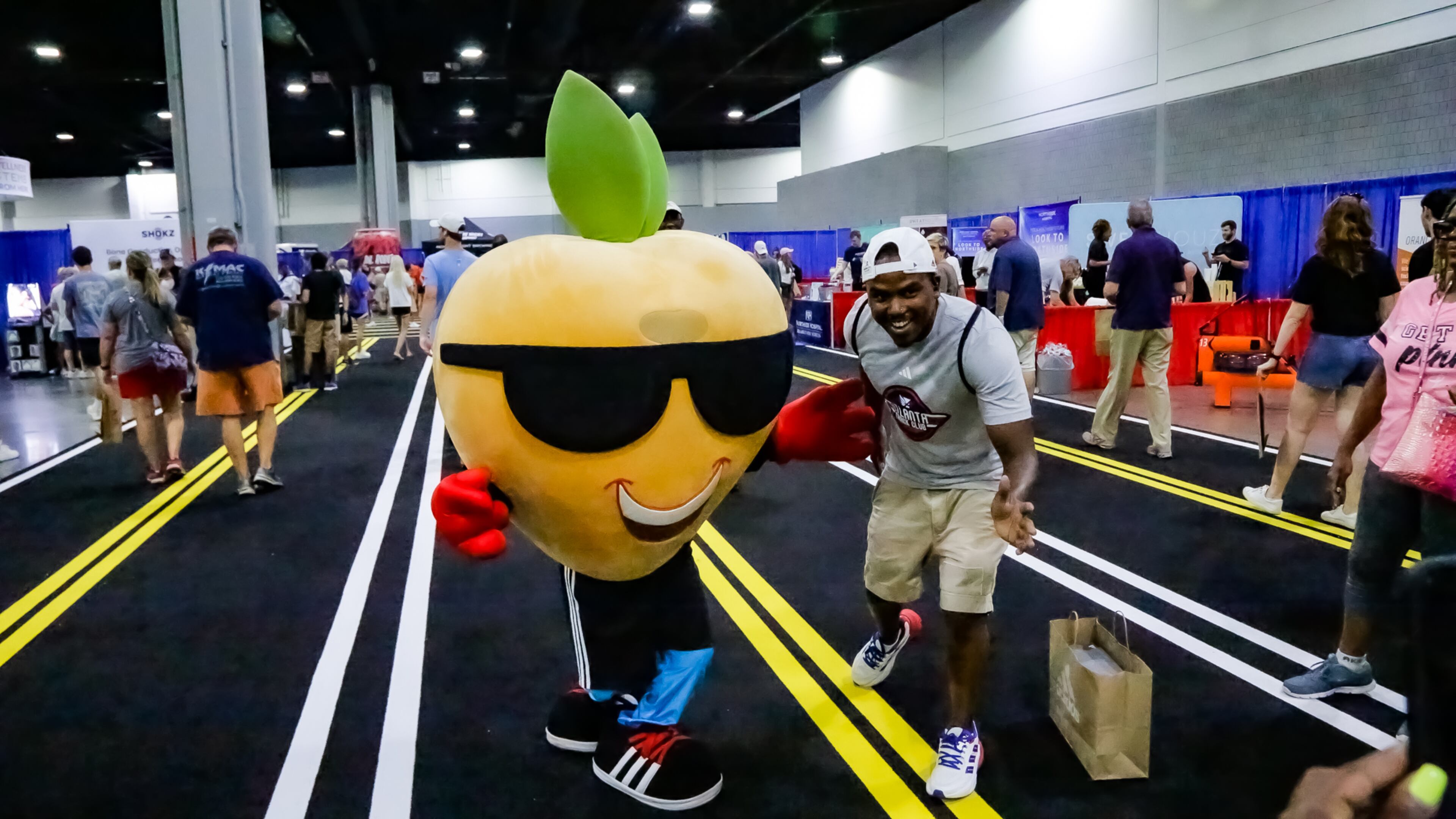 Pete the Peach greets runners at the 2023 Peachtree Health and Fitness Expo at the Georgia World Congress Center in Atlanta.