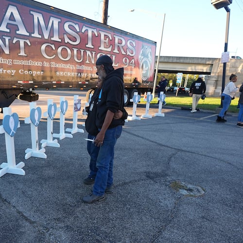FILE - Allen Wilson, right, hugs an attendee after they wrote on crosses for victims during a vigil Thursday, Nov. 6, 2025, in Louisville, Ky., after a UPS plane crashed at Louisville Muhammad Ali International Airport. (AP Photo/Darron Cummings, File)