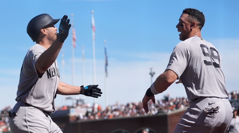 New York Yankees' Giancarlo Stanton, left, is congratulated by Aaron Judge after hitting a home run during the sixth inning of a baseball game against the San Francisco Giants in San Francisco, Friday, March 27, 2026. (AP Photo/Jeff Chiu)