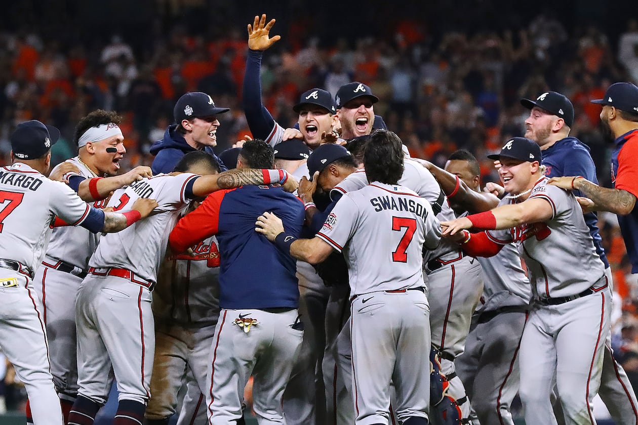 110221 HOUSTON: The Braves charge the mound to celebrate beating the Astros in game 6 to win the World Series on Tuesday, Nov. 2, 2021, in Houston. “Curtis Compton / Curtis.Compton@ajc.com”