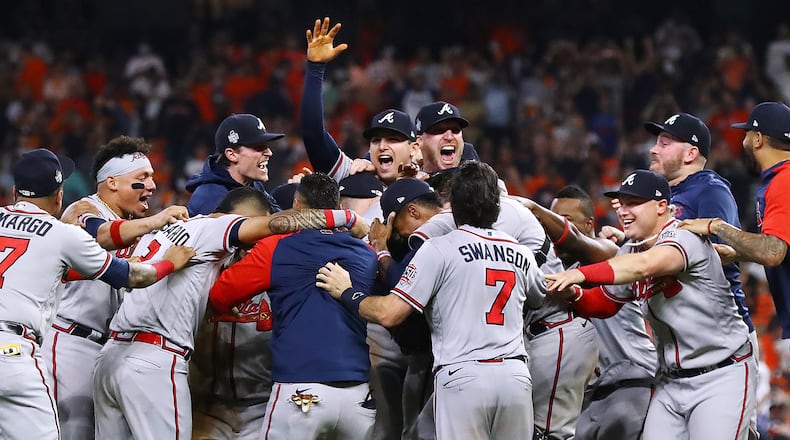 The Braves charge the mound to celebrate beating the Astros in Game 6 to win the World Series. (Curtis Compton / Curtis.Compton@ajc.com)