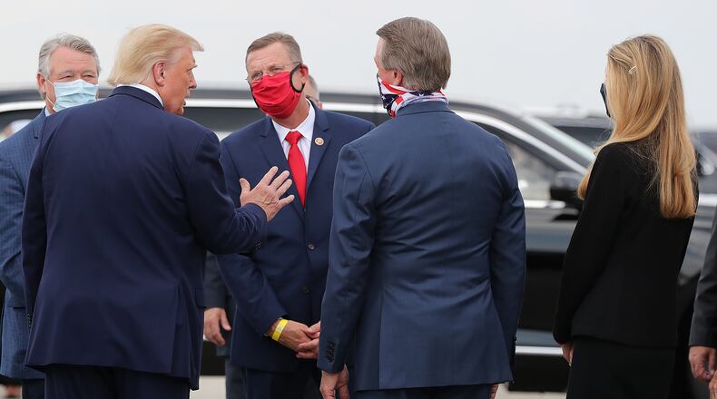 U.S. Rep. Rick Allen of Evans, far left, and U.S. Sen. Kelly Loeffler, far right, will attend in person President Donald Trump's speech Thursday from the White House to the Republican National Convention. U.S. Rep. Doug Collins of Gainesville, with red face covering, will not make it, nor will U.S. Sen. David Perdue, second from left, who recently underwent knee surgery. (Curtis Compton/Atlanta Journal-Constitution/TNS)