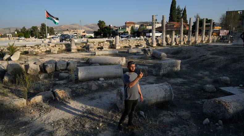 FILE - A Palestinian visitor takes a photo at the Roman historical site in the West Bank town of Sebastia Thursday, Nov. 20, 2025. (AP Photo/Nasser Nasser, File)