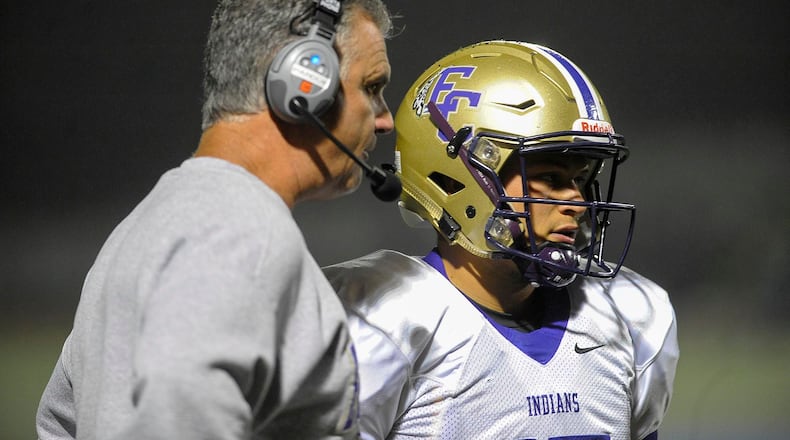 Smyrna, Ga. —East Coweta head coach Steve Pardue talks with senior QB Will LaGuardia (15) in the second quarter of their game at Campbell High’s McDaniel Stadium Friday, September 25, 2015. Special/Daniel Varnado