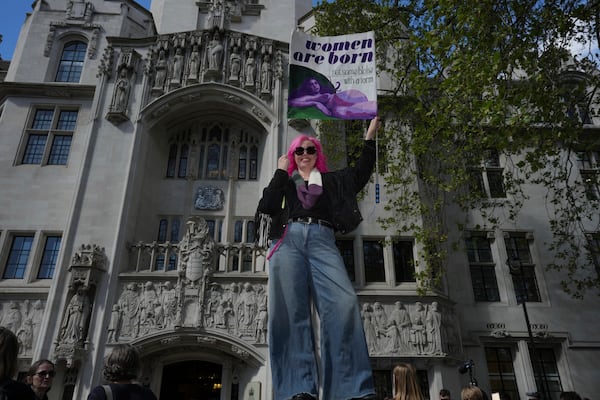 Women's rights activist celebrates outside the Supreme Court to challenge gender recognition laws, in London, Wednesday, April 16, 2025. (AP Photo/Kin Cheung)