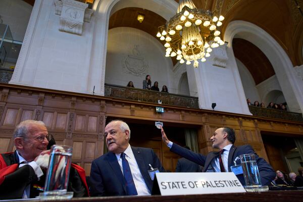 Palestinian Ambassador to the United Nations Riyad Mansour, center, and other members of the legal team wait for the International Court of Justice to open hearings into a United Nations request for an advisory opinion on Israel's obligations to allow humanitarian assistance in Gaza and the West Bank, in The Hague, Netherlands, Monday, April 28, 2025. (AP Photo/Peter Dejong)