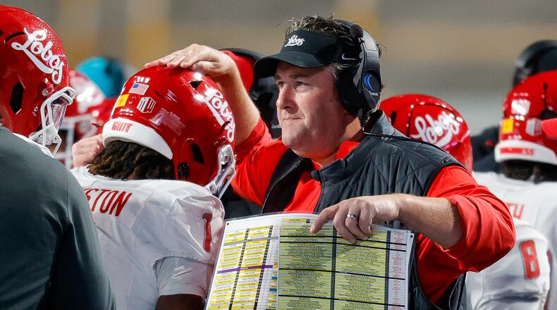 FILE - New Mexico head coach Jason Eck taps running back Damon Bankston (1) on the head after his long kickoff return for a touchdown in the first half of an NCAA college football game, Oct. 11, 2025, in Boise, Idaho. (AP Photo/Steve Conner, File)