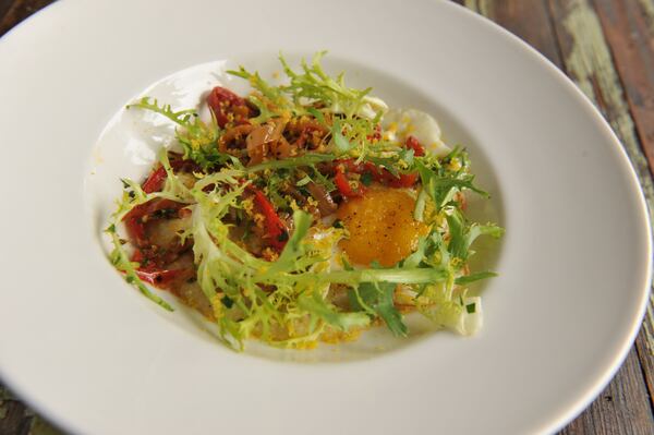 Cakes & Ale's Peperonata & Polenta features fried egg, frisee and bottarga.