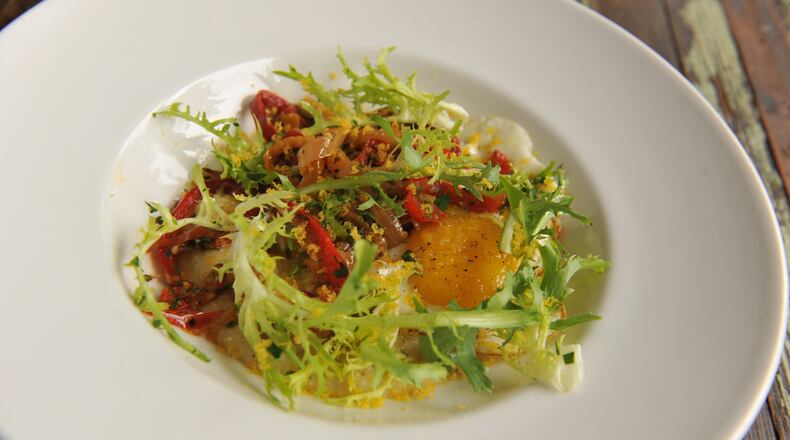 Cakes & Ale's Peperonata & Polenta features fried egg, frisee and bottarga.
