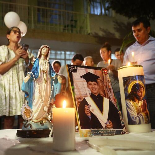 Friends and relatives hold a vigil for Johan Sebastián Durán Guerrero, a Colombian national who was fatally shot by an Immigration and Customs Enforcement officer in Maine, at his family home in Bucaramanga, Colombia, Tuesday, July 14, 2026. (AP Photo/Jaime Moreno)