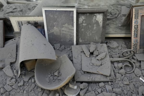 Dust covers framed family photos and personal objects at the site of a direct hit from an Iranian missile strike in Ramat Gan, Israel, Thursday, June 19, 2025. (AP Photo/Oded Balilty)