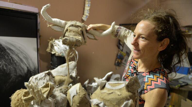 “Cloth” choreographer Lauri Stallings shows off some of the handmade animal mask dancers will wear during part of their performance at the Goat Farm in Atlanta. Brant Sanderlin/bsanderlin@ajc.com