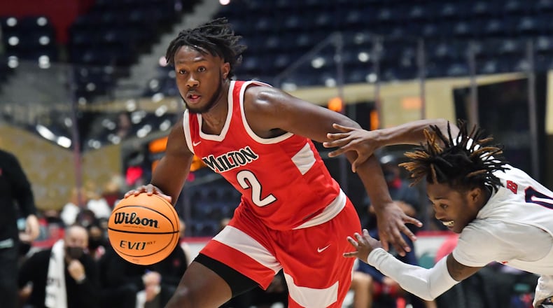 March 13, 2021 Macon - Milton's Bruce Thornton (2) drives past Berkmar's JaÕRon Ford (right) during the 2021 GHSA State Basketball Class AAAAAAA Boys Championship game at the Macon Centreplex in Macon on Saturday, March 13, 2021 Milton won 52-47 over Berkmar. (Hyosub Shin / Hyosub.Shin@ajc.com)