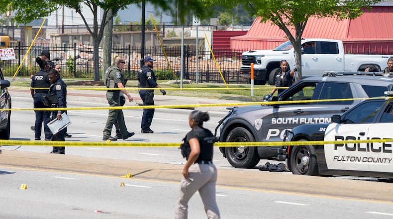 Multiple agencies arrive on the scene after two police officers were shot on Fulton Industrial Boulevard on Friday, April 18, 2025. (Ben Hendren for the AJC)