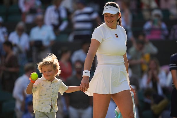 Amanda Anisimova of the U.S. celebrates with her nephew Jackson winning the women's singles quarter finals match against Anastasia Pavlyuchenkova of Russia at the Wimbledon Tennis Championships in London, Tuesday, July 8, 2025.(AP Photo/Kin Cheung)