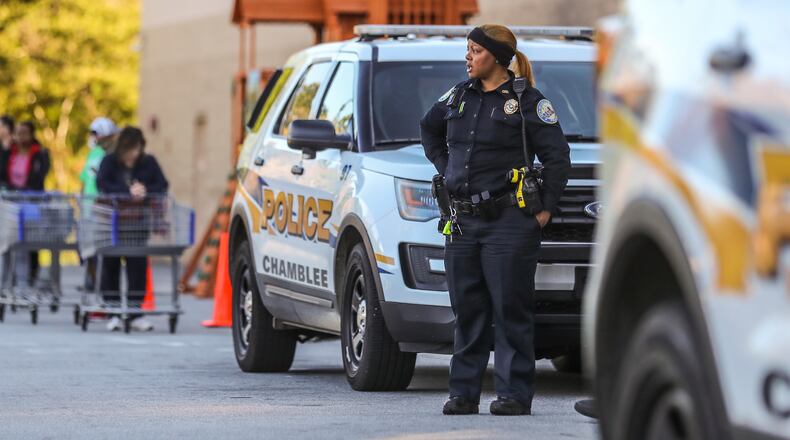 Customers lined up over the length of a football field at Sam's Club on Clairmont Road in DeKalb County on Friday, April 3, 2020. Chamblee police had an officer on site to monitor the crowd, which was being let into the store in lower numbers to retain social distancing amid the COVID-19 pandemic. JOHN SPINK/JSPINK@AJC.COM