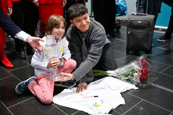 JJ, right, from Austria arrives at the airport in Vienna, Austria, Sunday, May 18, 2025, after winning the Grand Final of the 69th Eurovision Song Contest, in Basel yesterday. (AP Photo/Denes Erdos)