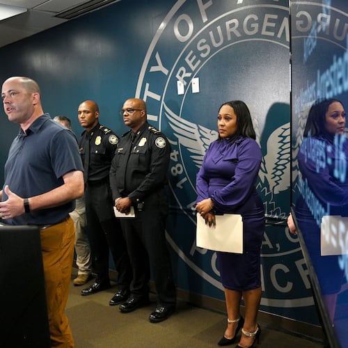 Georgia Attorney General Chris Carr speaks as Fulton County District Attorney Fani Willis (right) and other officials stand behind during a news conference on Operation Heatwave at APD Public Safety Headquarters in Atlanta. (Hyosub Shin/AJC 2023)