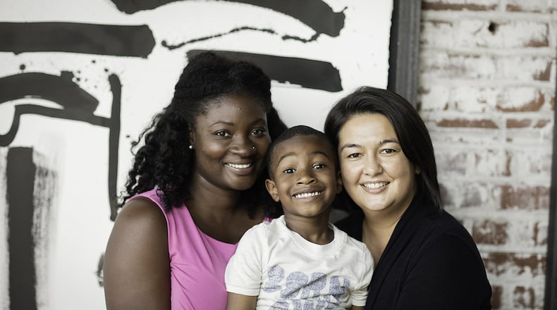 Queenyona Boyd (left), with her son Anthony and attorney Diana Rugh Johnson. Days after Boyd gave birth in 2011, Anthony was yanked from his parents because of a broken leg. Johnson proved the break occurred in the womb. Boyd’s story is being told again as part of the State Bar of Georgia’s Georgia Needs Lawyers campaign. CONTRIBUTED BY ROB BRINSON