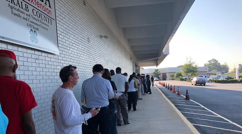 Dozens of people waited outside the DeKalb County tax commissioner’s central office on Memorial Drive in 2019. Tag offices across the region saw long lines as they reopened after launching a new state vehicle registration system. (DAVID WICKERT/AJC)