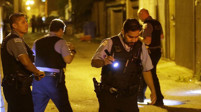 Chicago Police officers investigate the crime scene where a man was shot in the alley in the Little Village neighborhood on July 2, 2017, in Chicago, Illinois.
Local media reports that at least six people have been killed and dozens wounded in shooting as Chicago headed into July 3, and the July 4th Independence Day celebrations. / AFP PHOTO / Joshua Lott (Photo credit should read JOSHUA LOTT/AFP/Getty Images)