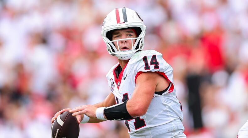 Georgia quarterback Gunner Stockton (14) looks to throw during the first half of an NCAA college football game against Western Kentucky, Saturday, Sept. 12, 2026, in Athens, Ga. (AP Photo/Colin Hubbard)