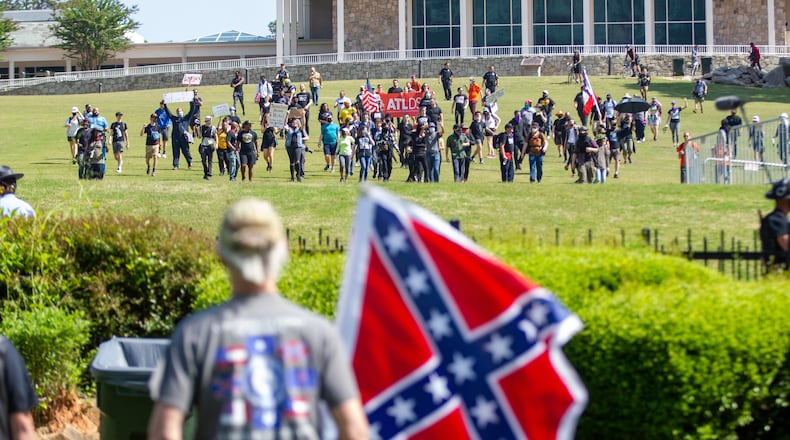 Members of the Sons of Confederate Veterans were met by counterprotesters - the two sides separated by a fence - during a rally to mark Confederate Memorial Day at Stone Mountain Park on Saturday, April 30, 2022. (Photo: Steve Schaefer / steve.schaefer@ajc.com)