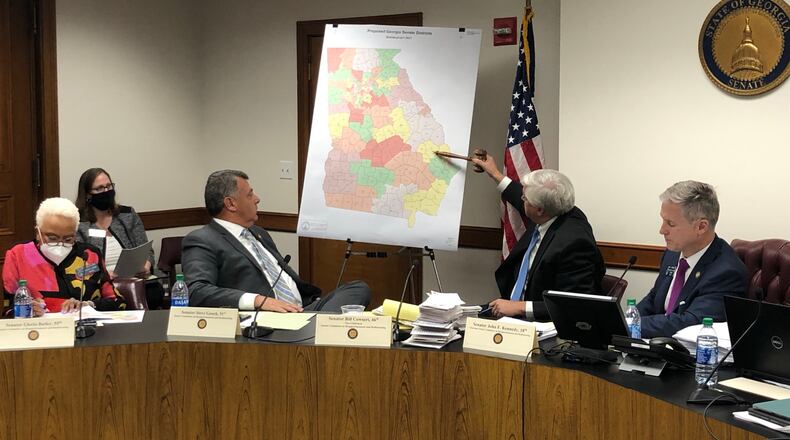 State Sen. Bill Cowsert, a Republican from Athens, points to new Senate districts during a committee meeting Thursday. From left: Sens. Gloria Butler, D-Stone Mountain; Steve Gooch, R-Dahlonega; Cowsert; and Redistricting Chairman John Kennedy, R-Macon. MARK NIESSE / MARK.NIESSE@AJC.COM